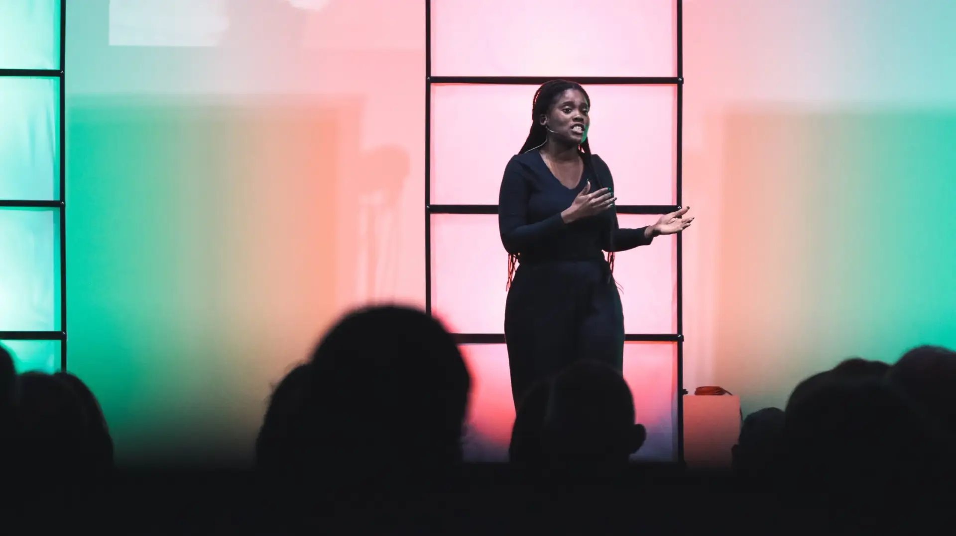 Woman speaking on stage in front of an audience